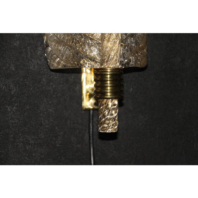 This beautiful pair of sconces was individually designed and made in Murano, in a very rich and deep golden color glass....