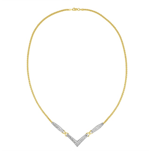 This stunning 14K yellow and white gold pendant necklace features flared rectangle shapes followed by X-shaped links...