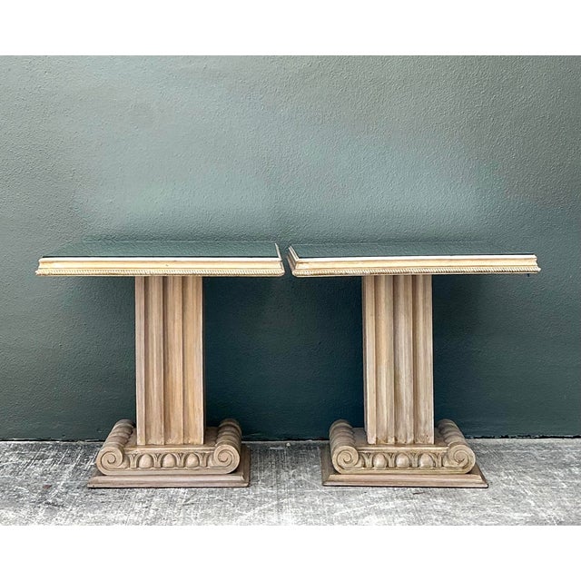 This exquisite pair of side tables by John Stuart Inc. perfectly embodies the Neoclassical revival aesthetic famously...