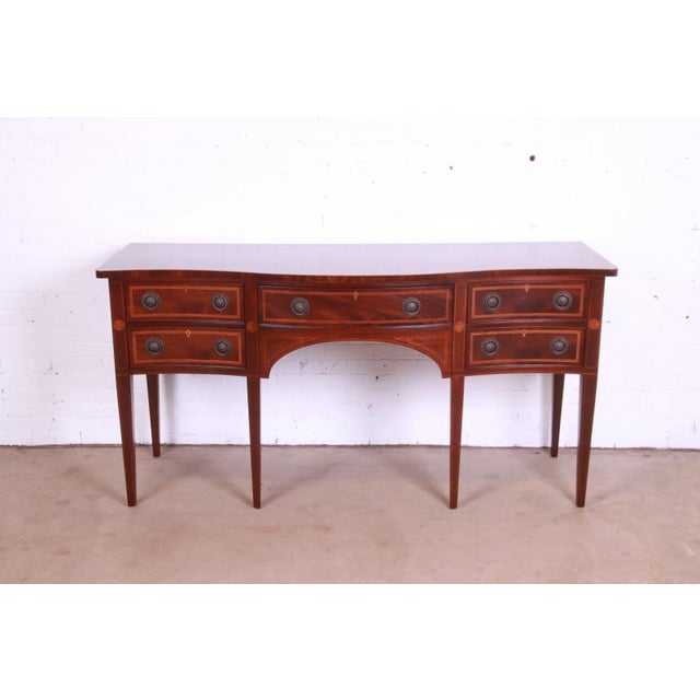 An exceptional Hepplewhite or Federal style serpentine front sideboard, buffet, or credenza By Baker Furniture USA,...