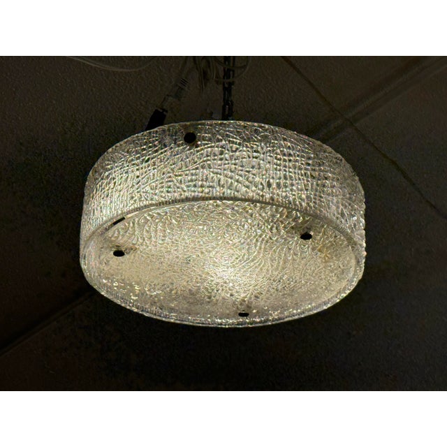 Design Plus Gallery presents the Ice Glass Flush Mount from Kaiser Leuchten. The highly textured glass shade over the...