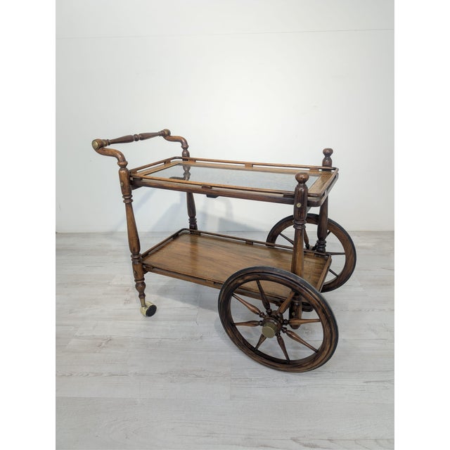 Antique mobile bar with carved, openwork ballet decorations Antique, wooden mobile bar on wheels with carved, openwork...