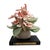 Vintage handcrafted fabric floral bouquet in soft shades of pink and peach with green leaves, gathered on an off-white...