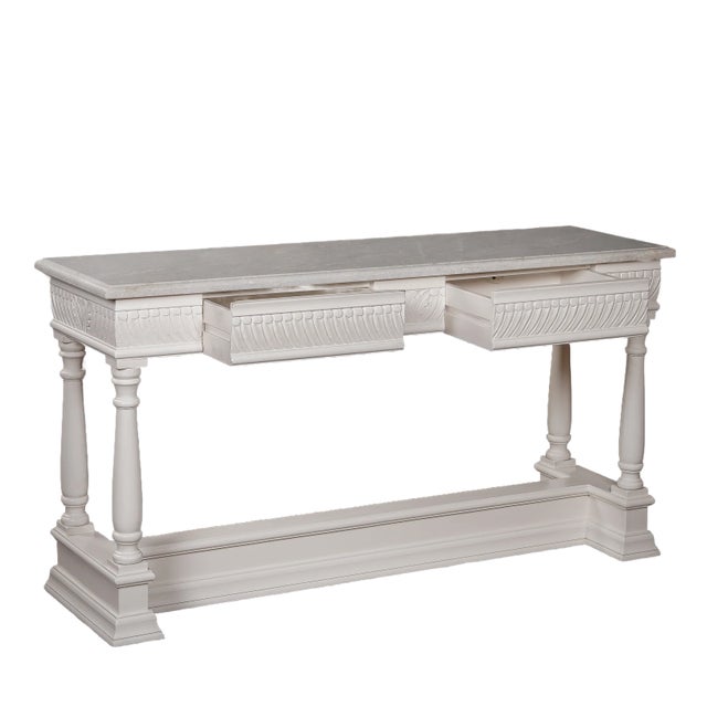 Crafted by skilled artisans, the Greenwich Console boasts two drawers with intricate details and a smooth alabaster marble...
