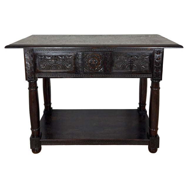 Impressive 19th century Spanish console table crafted in solid oak, featuring richly carved drawer fronts with floral and...