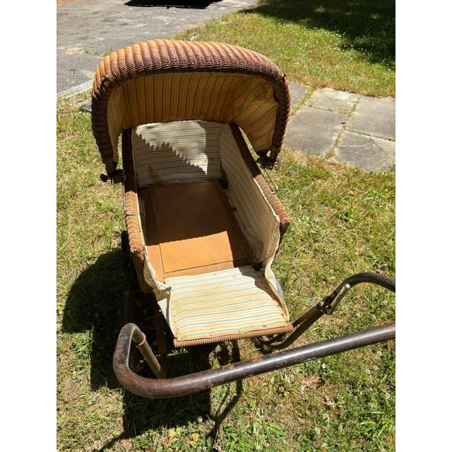 Late 1880's to turn of 20th century wicker pram in excellent condition. This is an older pram with wooden spoked and...