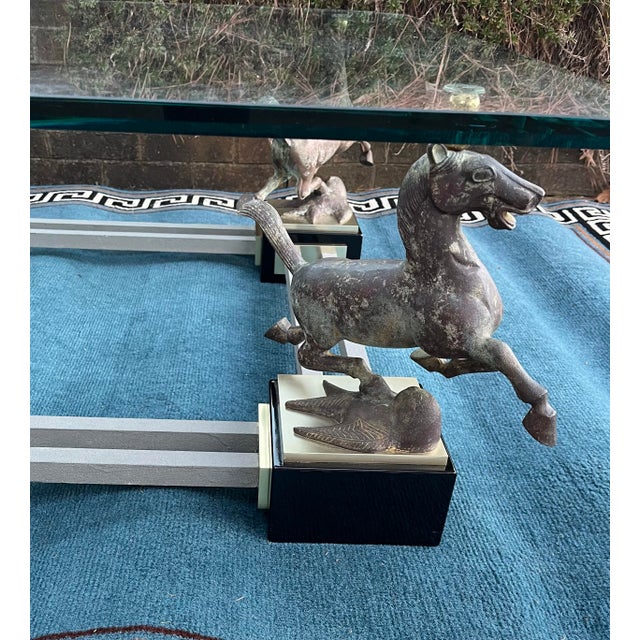 This Gorgeous 1970s French Maison Charles Flying Horses of Gansu Bronze & Brass Cocktail Table is unique in design....