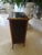 An exquisite bookcase with a fabulous lacquered top showcasing a bird and flowers.
