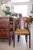 A handsome set of six French Empire–style dining chairs crafted in richly toned walnut, circa 1920. The chairs feature...