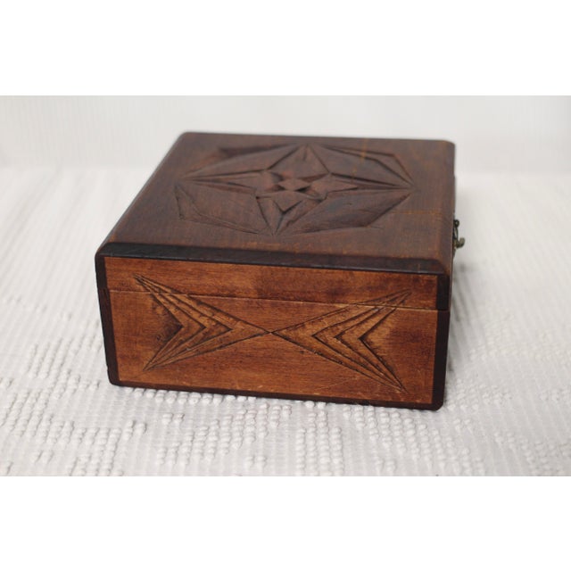 A beautiful wooden box carved with a geometric design and a silk interior. Probably from the early 1900s and very similar...
