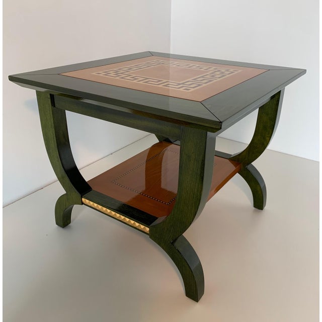This coffee table was produced in Italy in the 80s a it is in green aniline with a fine maple inlay reminiscent of the...
