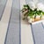 Wide bands of micro stripes, structured with crisp, banded edges on an ivory ground, bring modern balance and subtle...