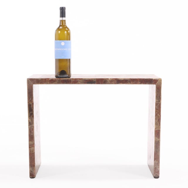The rectangular top finely inlaid with a shimmering marquetry surface of natural mica, displaying subtle black, brown, and...