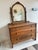 Beautiful antique wooden dresser with an attached mirror, featuring ornate legs and spindle details that give it a classic...