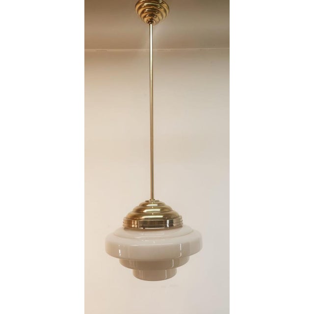 Brass and Glass Ceiling Lamp, in Very Good conditions. Designed 1920 to 1949 Up to 250V (Europe/UK Standard).The wiring of...