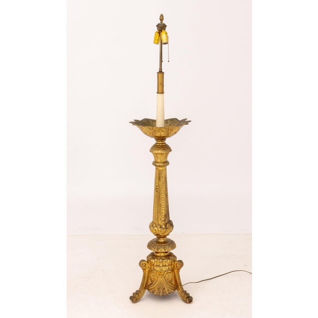 Gothic Revival Gilt Bronze Floor Lamp, the column body on three stepped scroll form feet. 63" H x 15.75" W x 13.5" D....