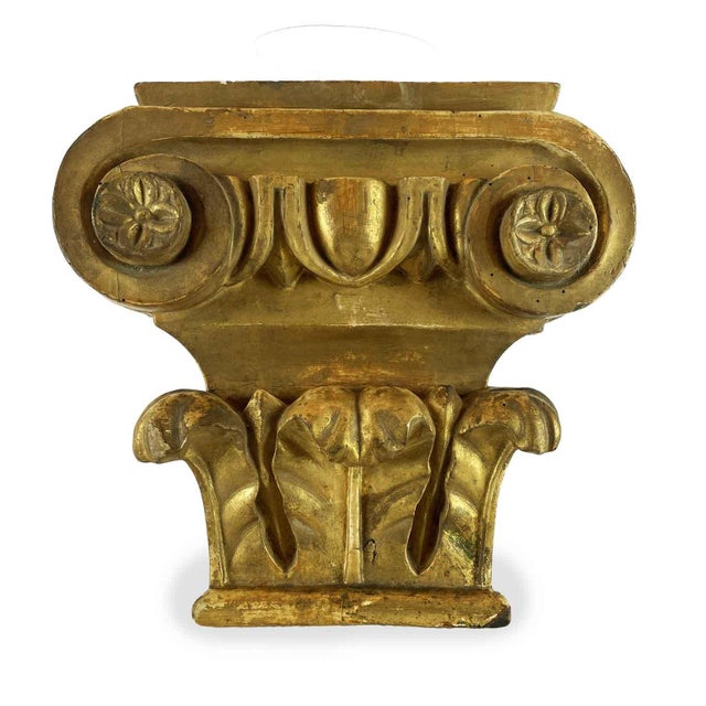 A pair of gilded poplar capitals from the 1800s, originally part of a larger decorative ensemble. In a composite style,...