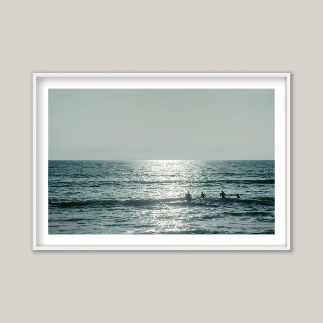 Four surfers braving the cold winter sun and sea on England’s south coast. East Wittering, perched on Bracklesham Bay, is...