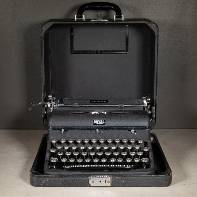 ABOUT An antique Royal Aristocrat typewriter with black, crinkle finish and original case. The keys are nickel and glass...