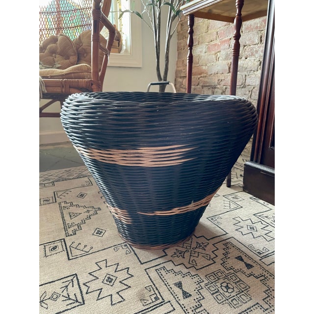 Large wicker basket planter measuring 14"H x 18"W. Likely mid-century. Dominant color is soft black with beige/natural...