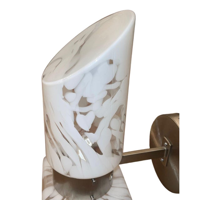 Elegant 1970's Murano glass wall sconce featuring a sculptural hand-blown glass shade with dramatic organic white mottled...