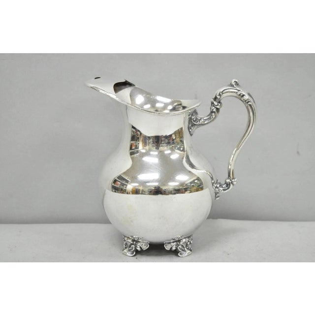 Vintage Poole Victorian Silver Plated Bulbous Footed Water Pitcher w/ Ice Lip. Circa Mid 20th Century. Measurements: 9" H...