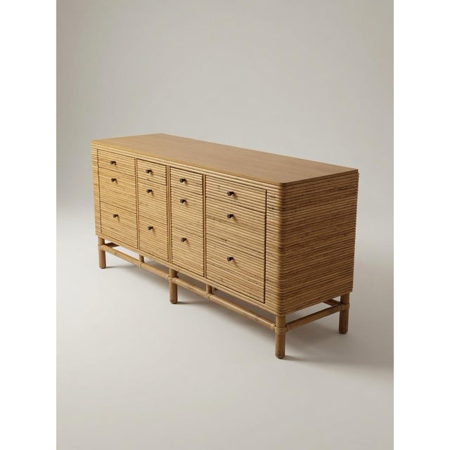 Stunning vintage dresser is crafted from pencil rattan with a smooth wood top. This piece has twelve drawers arranged in...