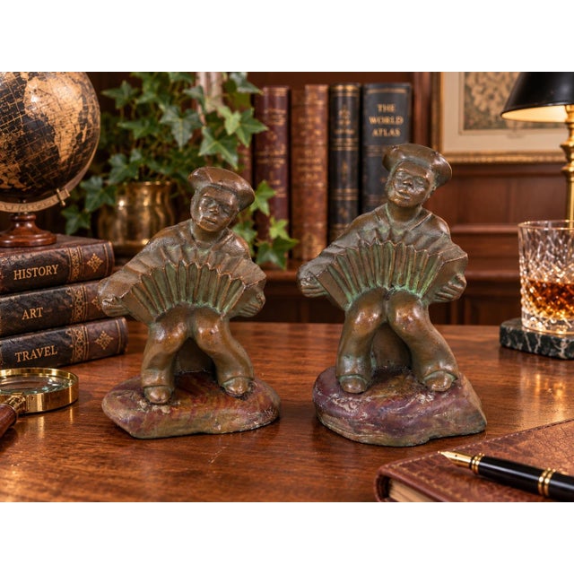 A wonderfully characterful matched pair of early American Hubley Manufacturing Company No. 497 cast-iron accordion player...