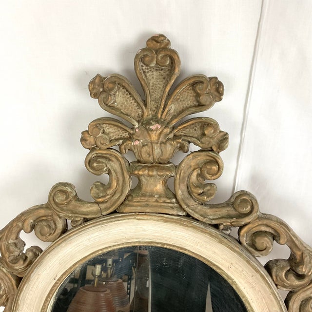 Elevate your interior with this striking pair of ornately carved wall mirrors, inspired by classic Italian Baroque design....