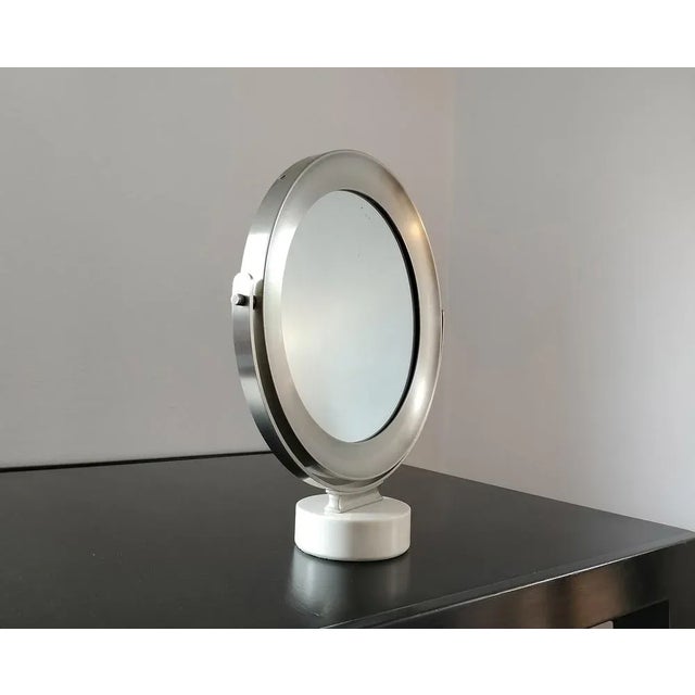 Narciso table mirror it's a fully swivel mirror with a matt nickel plated brass frame and a base in white marble. Designed...