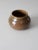 A vintage studio pottery vase signed by the artist, Barrett. The hand-crafted form features a warm two-tone brown speckled...