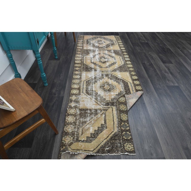 Vintage Hand-Knotted runner rug is a semi-antique vintage runner rug. The '70s Eastern region of Anatolia's unique rug is...