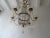 Housing 6 lights, sitting in crystal bobéches, dripping with white opaline beads and vintage crystal prisms. Will be...