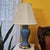 Vintage porcelain urn lamp featuring a luminous glossy blue glaze paired with a polished brass-tone base and hardware....