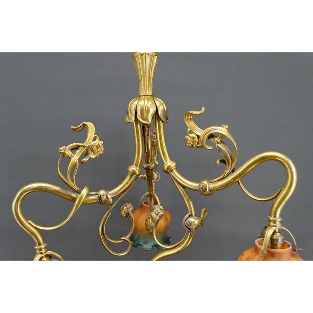Superb Art Nouveau chandelier in gilded bronze with floral/plant motifs, formerly gas powered, electrified. 4 lights....
