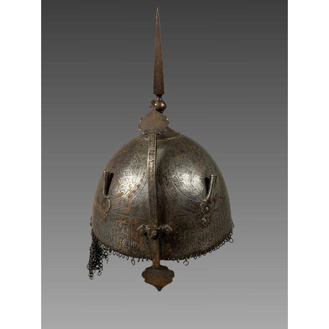 Indo-Persian "Kulah-Khud" Helmet . The helmet is made of engraved and damascened steel, decorated with an epigraphic...