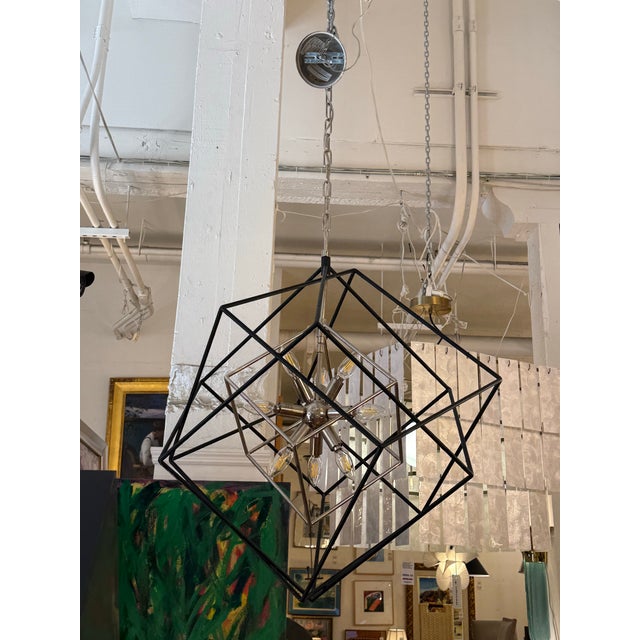 Design Plus Gallery presents the Roundout Nine-Light Chandelier by Hudson Valley Lighting. Intersecting hammered black...