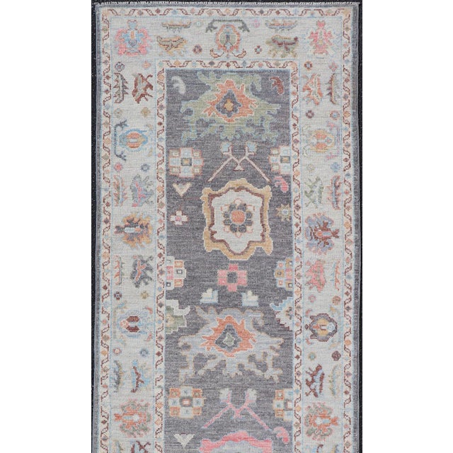 This Afghan Oushak runner features a grand motif, showcasing from the border to the field with a vibrant elegance that...
