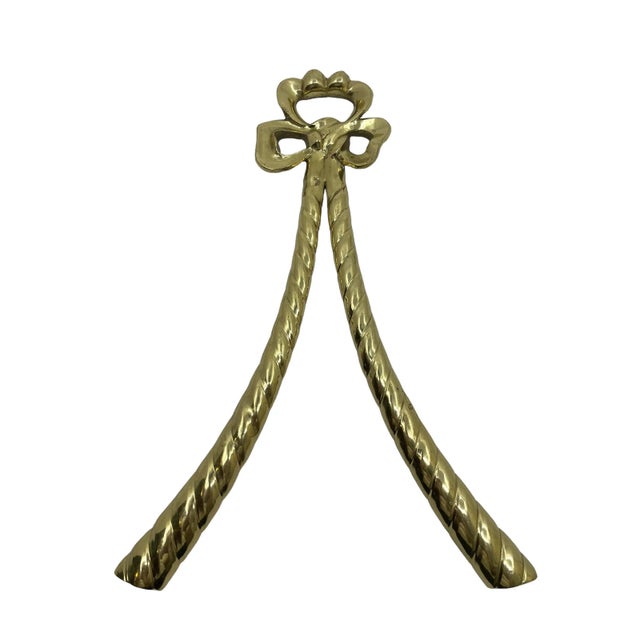 Vintage decorative brass bow. Great to hang above a picture or mirror. Metal bow that has been coated in Brass.