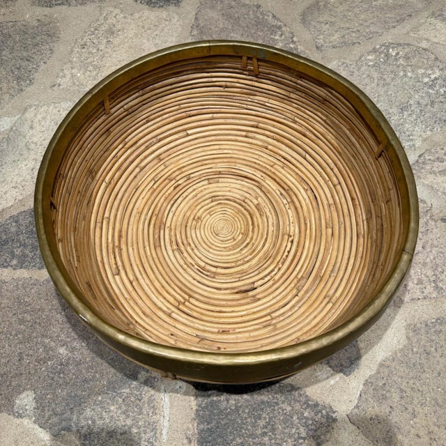 For your consideration, a vintage Mid-Century Modern pencil reed rattan and brass centerpiece bowl, heavily inspired by or...