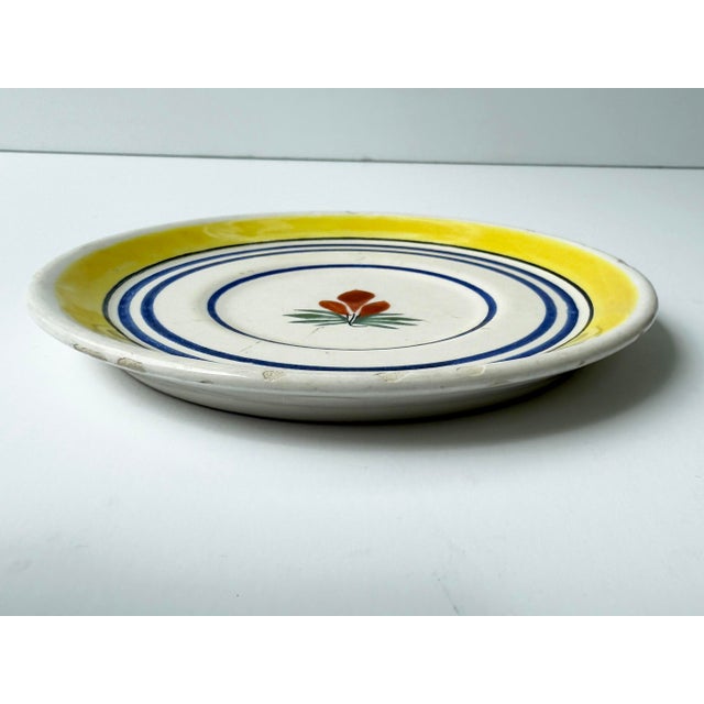 Antique plate with hand painted flower. Marked "Henriot Quimper France 724"