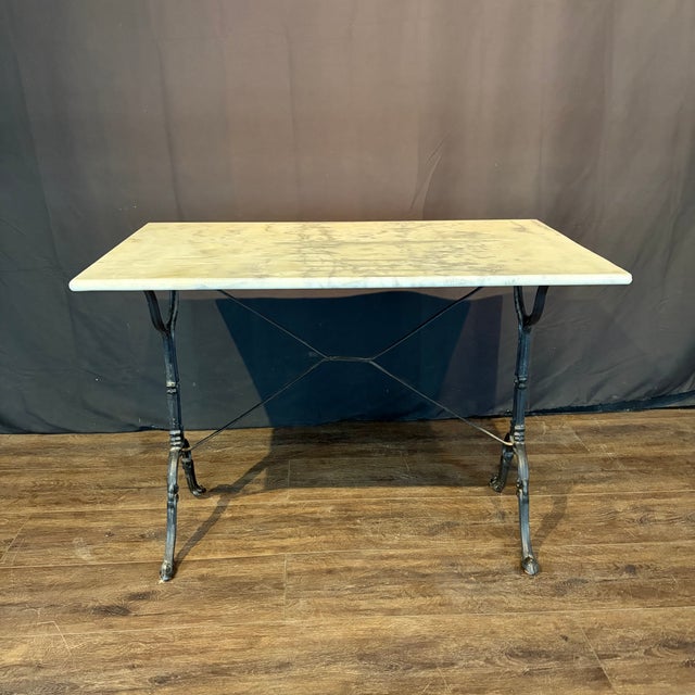 Classic and versatile French marble top gray cafe table or writing desk with a classic Provincial iron base. Marble is a...