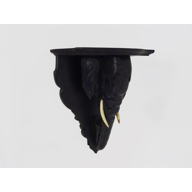 Sellette, plant holder, wall statue holder, elephant head sconce in blackened wood. End of XIXth century Sellette or wall...