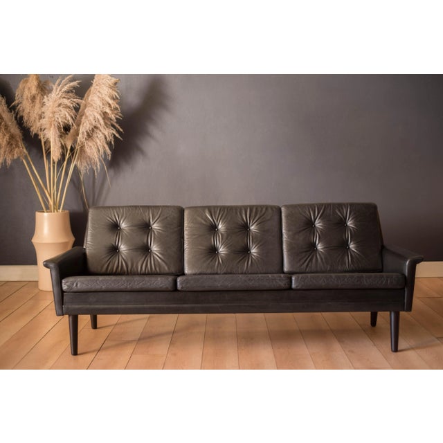 Mid century modern 3-seater sofa in rosewood and leather circa 1960's, Denmark. This comfortable statement piece can be...