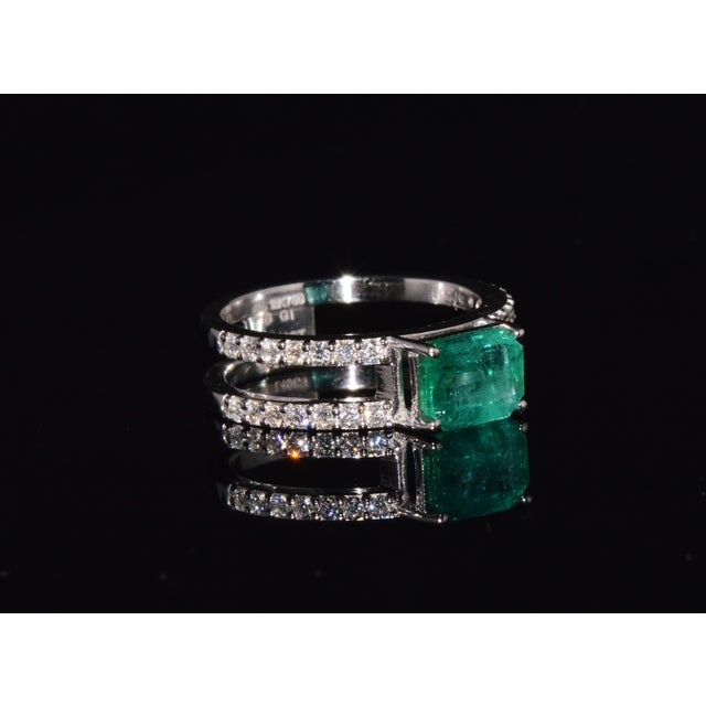 Certified natural 1.84CTS emerald and diamond solid 18K white gold ring. This elegant contemporary ring features a natural...