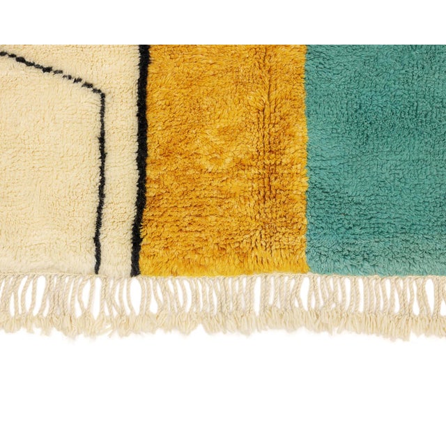 Vibrant hand-knotted wool rug featuring a bold abstract collage of Teal, Mustard, Taupe, and Midnight Black, accented with...