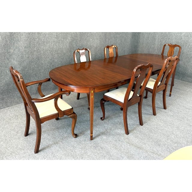 This 7-piece Henkel Harris mahogany dining set includes the No. 2224 inlaid dining table and six No. 109 Queen Anne-style...