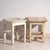 A pair of antique bedside tables in pine wood, with a square top and four tapered legs tied by box stretchers. They...