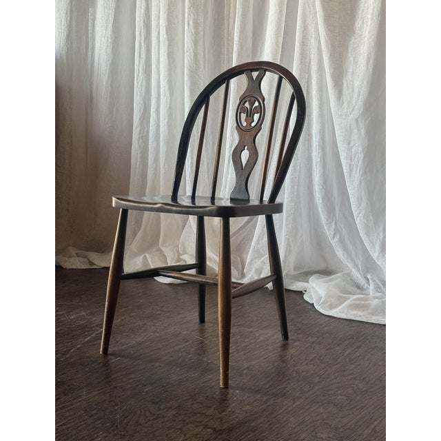 This charming set of four vintage dining chairs features elegant oval-shaped backs with delicate carved and pierced center...