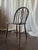 This charming set of four vintage dining chairs features elegant oval-shaped backs with delicate carved and pierced center...